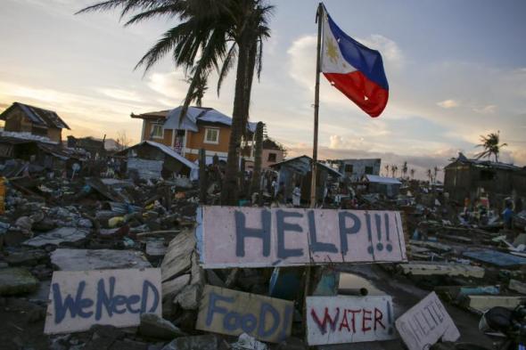 (photo courtesy of www.ibtimes.com) Taken two weeks after Haiyan devastated Tacloban. Government efforts were not well co-ordinated to distribute relief goods. 